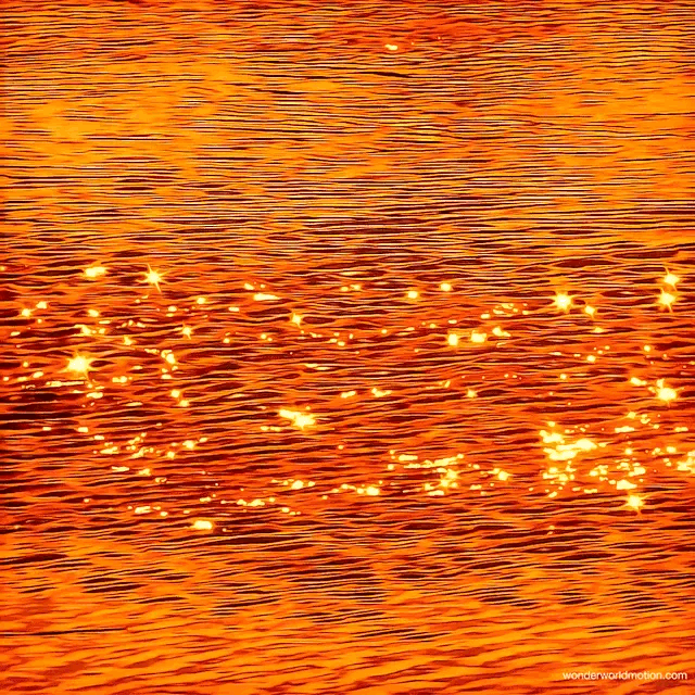 Sparkling orange water reflecting a sunset